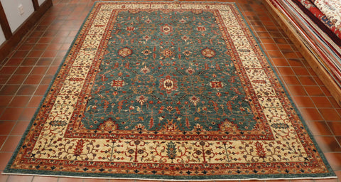 With striking blue-green background that makes this carpet so unusual and the wide cream border gives it a lift, whilst the touches of rusty terracotta give it some warmth.  Throughout, the design is one of interconnecting stylized flowers and leaves.  