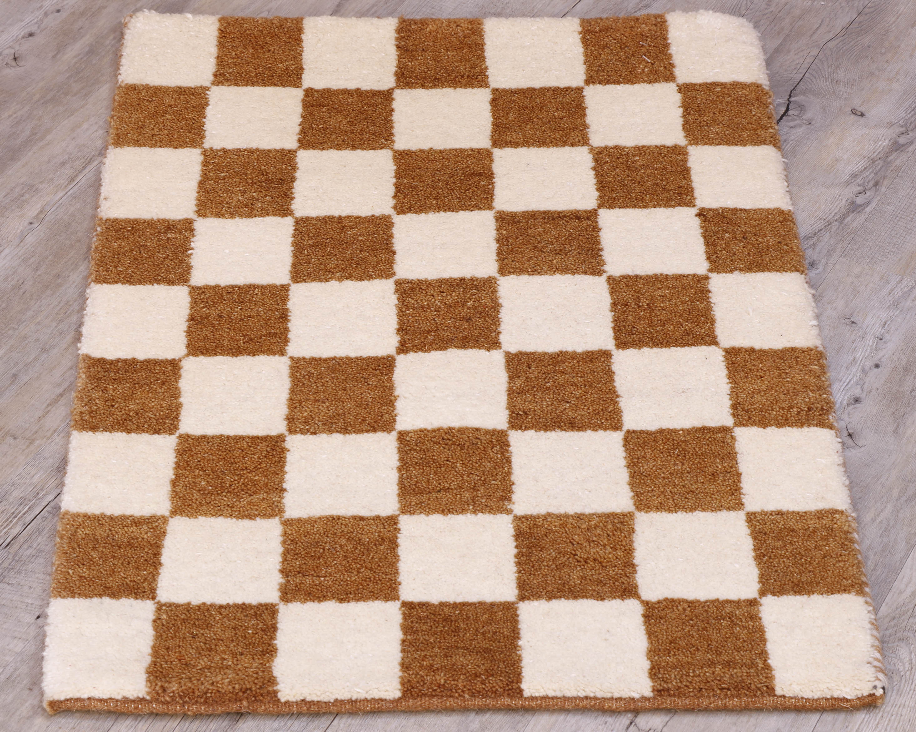 This small mat has a chequerboard design across it using cream and tan. 