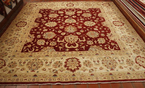 Large carpet with deep red central ground and warm cream ivory.  Floral decoration using the same colours with the addition of blue and a fawn shade. 