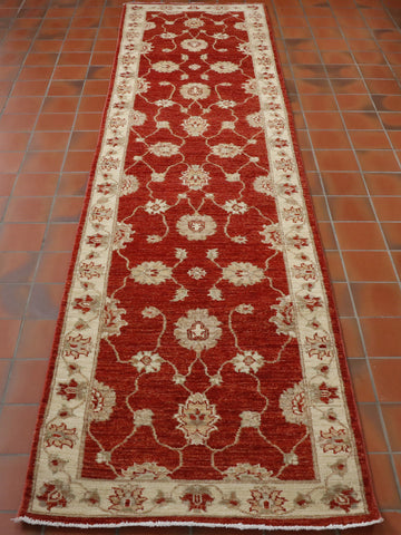 Brick red background with a cream border.  Decoration in old gold, red and cream. 